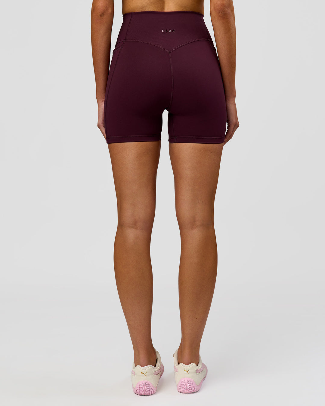 Woman wearing Fusion V-Contour Ultra High-Rise 4" Short Pockets - Cherry Lacquer | Model:Taneisha | Size:XS - view 11