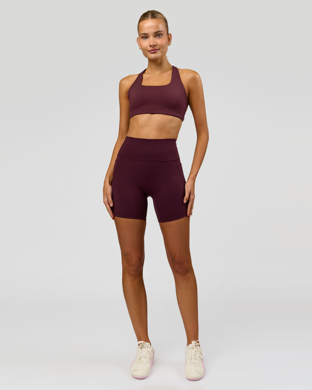 Woman wearing Fusion V-Contour Ultra High-Rise 6" Short Pockets - Cherry Lacquer | Model:Taneisha | Size:XS - view 3