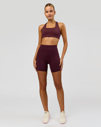 Woman wearing Fusion V-Contour Ultra High-Rise 6" Short Pockets - Cherry Lacquer | Model:Taneisha | Size:XS | Thumbnail Index: 2