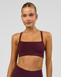 Woman wearing Momentum Sports Bra - Cherry Lacquer | Model:Taneisha | Size:XS | Thumbnail Index: 6
