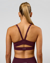 Woman wearing Momentum Sports Bra - Cherry Lacquer | Model:Taneisha | Size:XS | Thumbnail Index: 4