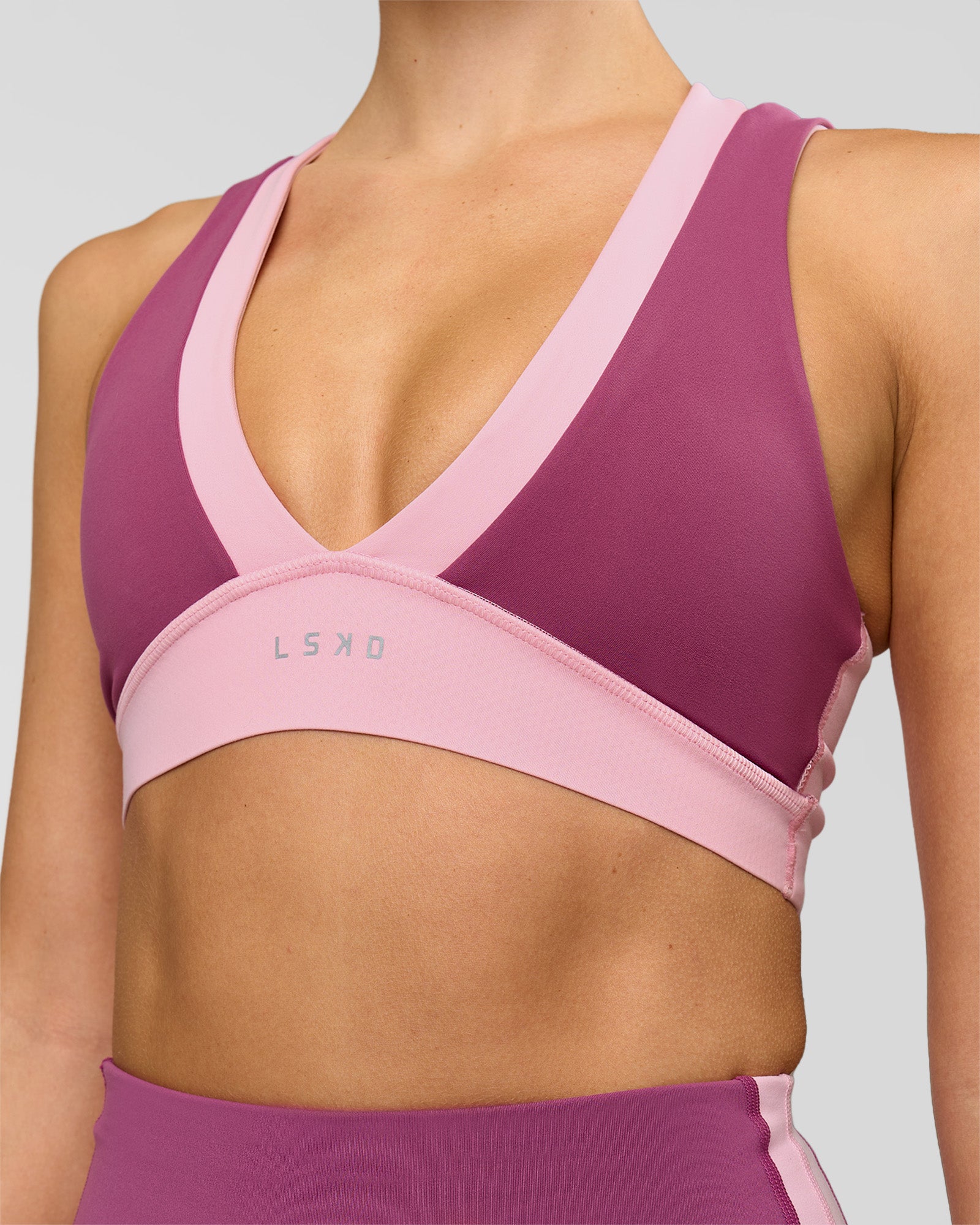 Woman wearing Stamina Layered Sports Bra - Boysenberry-Pink Rose | Model:Taneisha | Size:XS