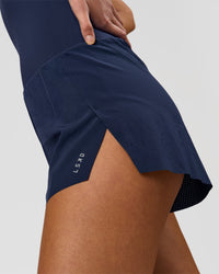 Woman wearing Tia-Clair Toomey-Orr Legacy 3" Run One-Piece - Future Navy | Model:Taneisha | Size:XS | Thumbnail Index: 13