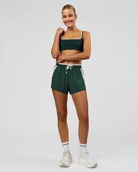 Woman wearing Trackline Accelerate 3" High-Rise Running Short - Midnight Green-White | Model:Taneisha | Size:XS | Thumbnail Index: 17