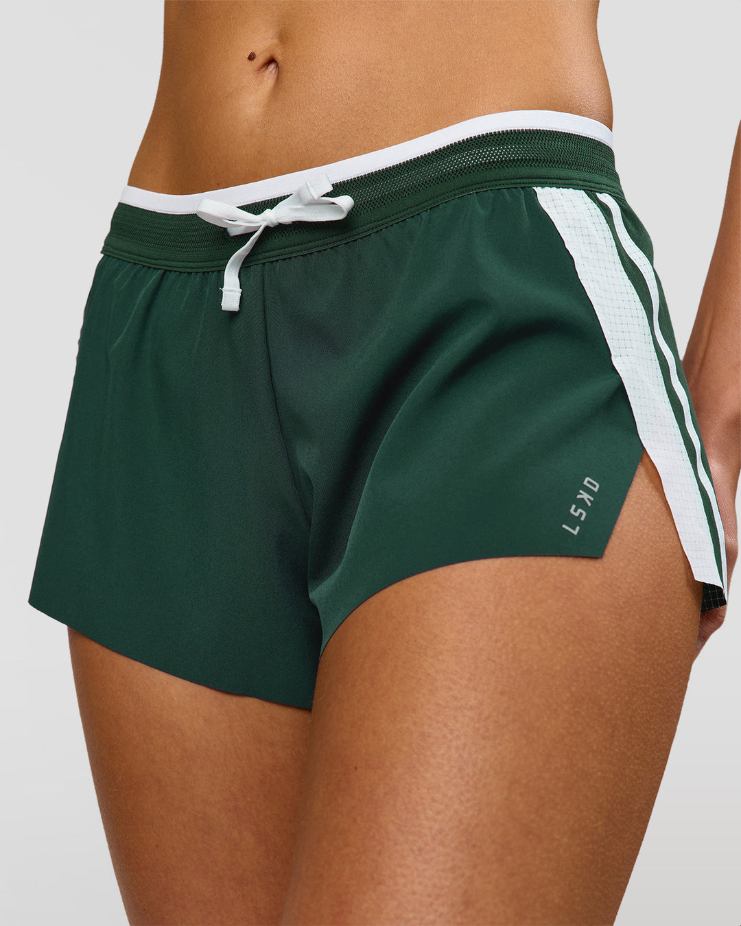 Woman wearing Trackline Accelerate 3" Mid Rise Running Short - Midnight Green-White | Model:Taneisha | Size:XS - view 1