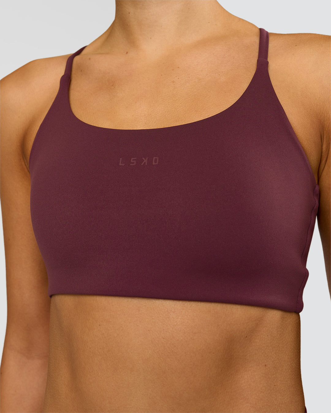 Woman wearing Twist Sports Bra - Cherry Lacquer | Model:Taneisha | Size:XS - view 2
