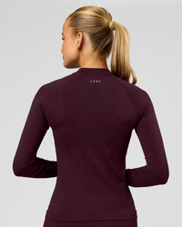 Woman wearing AeroFLX+ Long Sleeve Half Zip - Cherry Lacquer/Cherry Laquer | Model:Taniesha | Size:XS | Thumbnail Index: 1