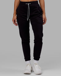 Woman wearing Unisex Capsule Track Pant - Black | Thumbnail Index: 7