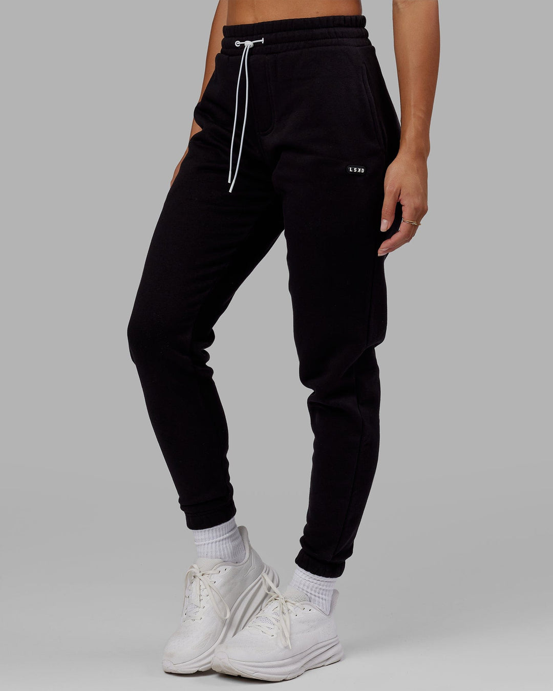 Woman wearing Unisex Capsule Track Pant - Black - view 9