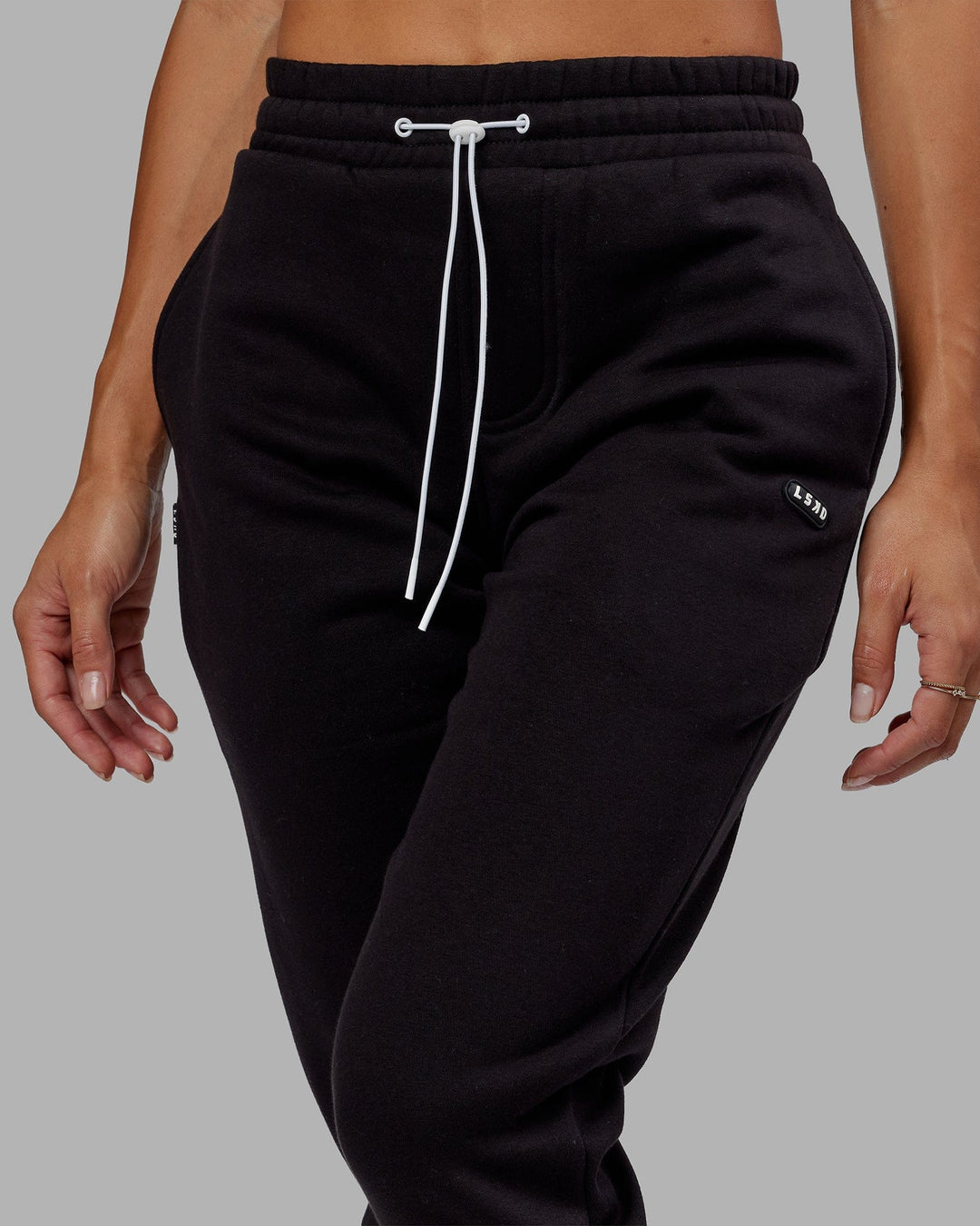 Woman wearing Unisex Capsule Track Pant - Black - view 6