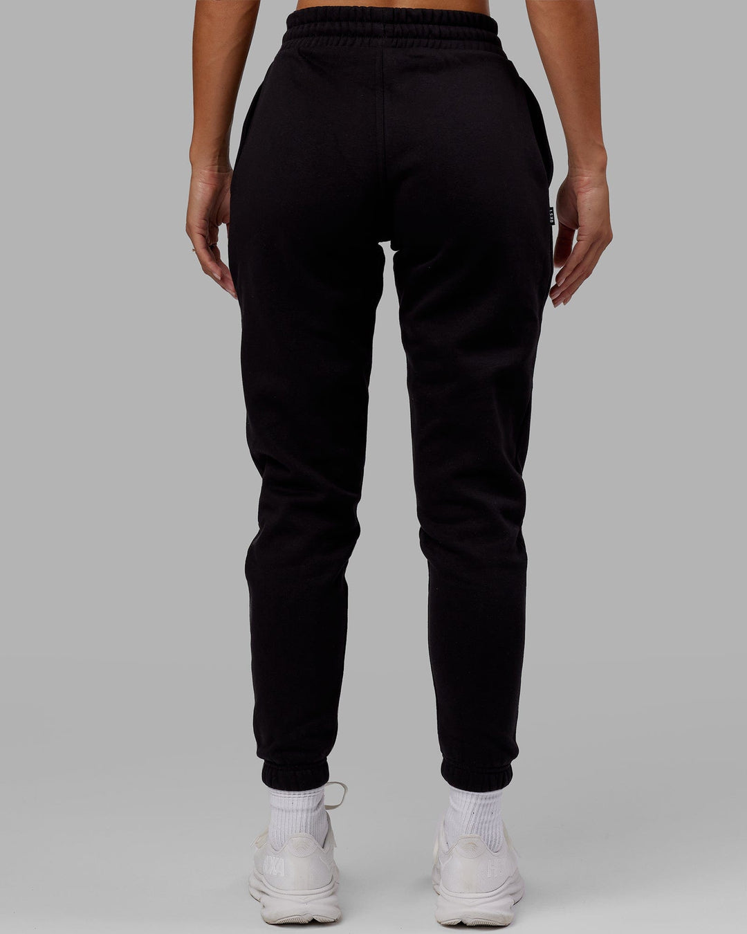 Woman wearing Unisex Capsule Track Pant - Black - view 10
