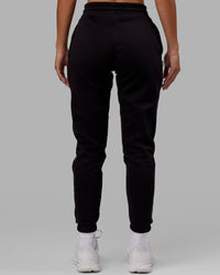 Woman wearing Unisex Capsule Track Pant - Black | Thumbnail Index: 9