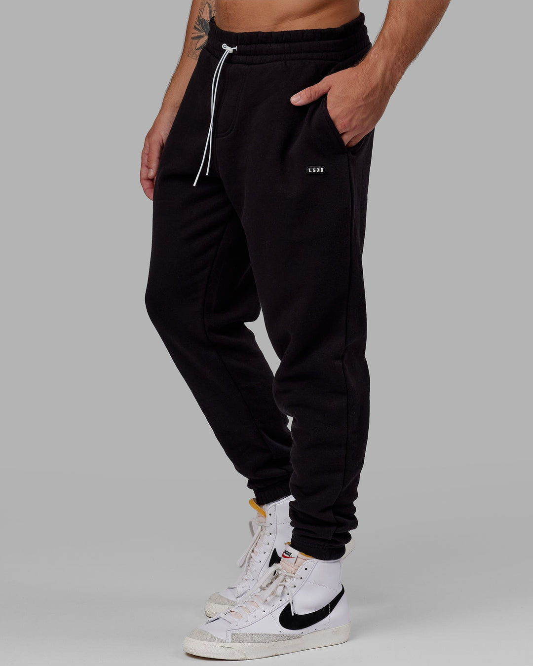 Man wearing Unisex Capsule Track Pant - Black - view 2