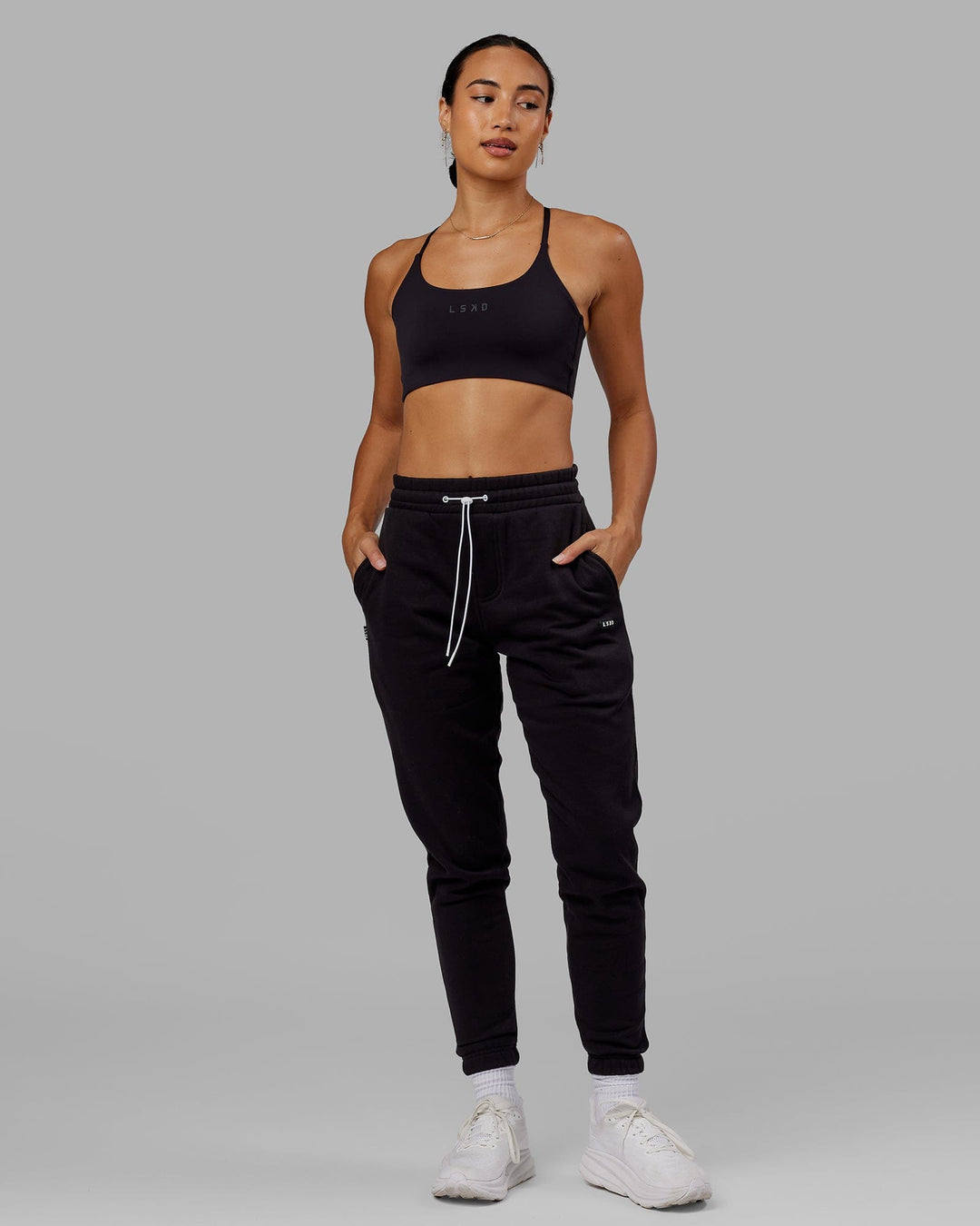 Woman wearing Unisex Capsule Track Pant - Black - view 5