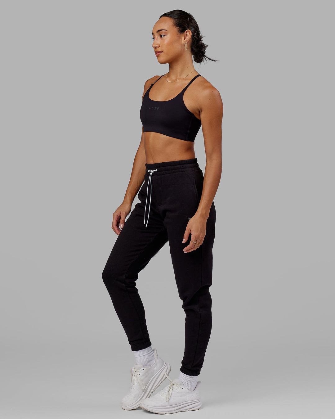 Woman wearing Unisex Capsule Track Pant - Black - view 7