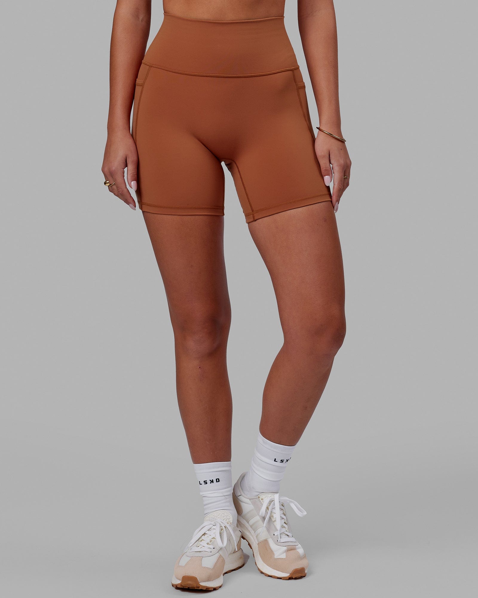 Woman wearing Fusion Ultra High-Rise 6" Short Pockets - Hazel | Set:true | Angle:front | Model:Milly | Size:S