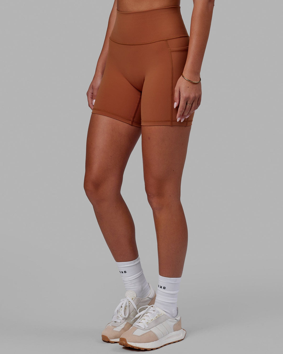 Woman wearing Fusion Ultra High-Rise 6" Short Pockets - Hazel | Set:true | Angle:side | Model:Milly | Size:S - view 7