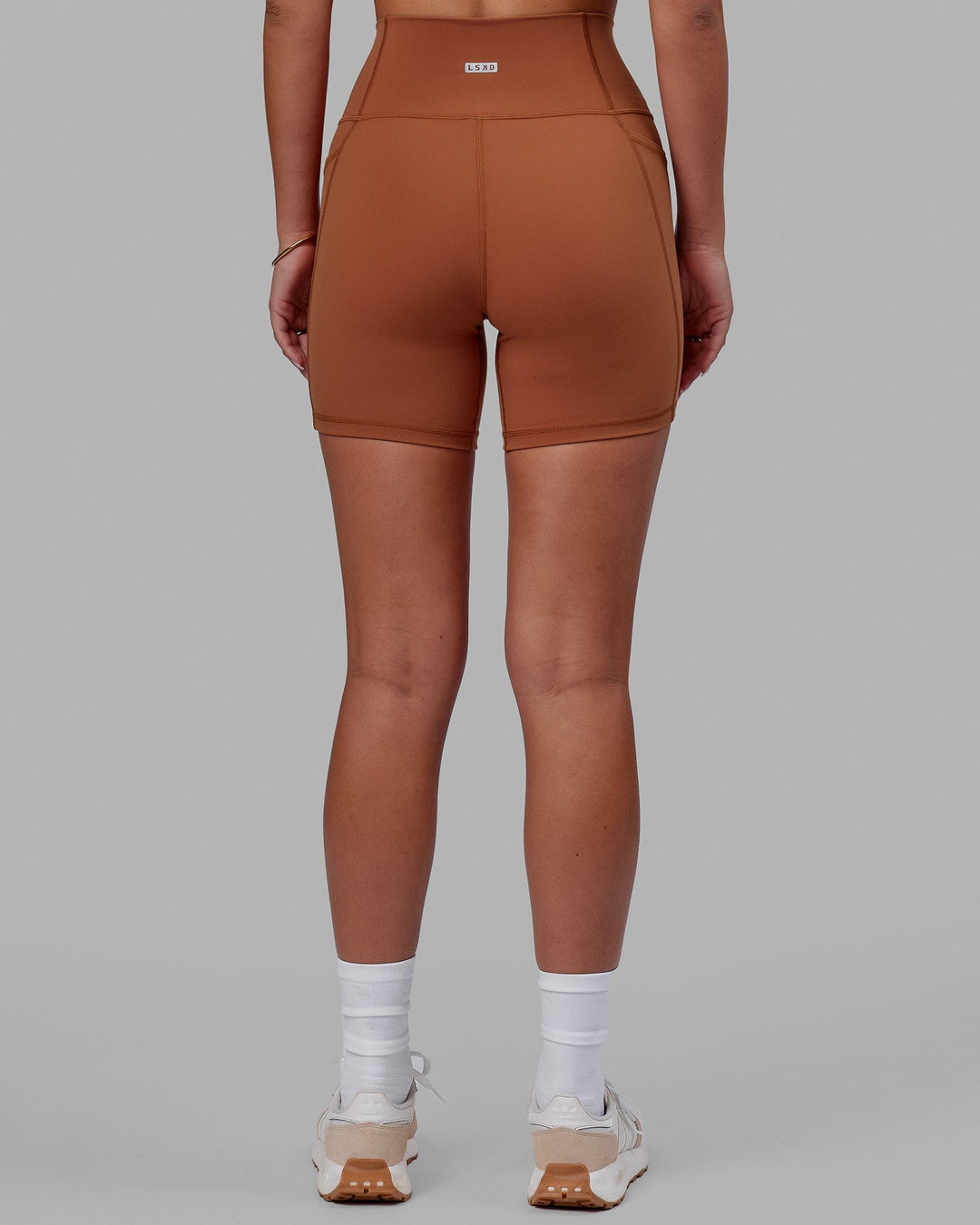 Woman wearing Fusion Ultra High-Rise 6" Short Pockets - Hazel | Set:true | Angle:back | Model:Milly | Size:S - view 4