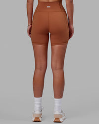 Woman wearing Fusion Ultra High-Rise 6" Short Pockets - Hazel | Set:true | Angle:back | Model:Milly | Size:S | Thumbnail Index: 3
