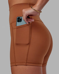 Woman wearing Fusion Ultra High-Rise 4" Short Pockets - Hazel | Model:Milly | Size:S | Thumbnail Index: 0