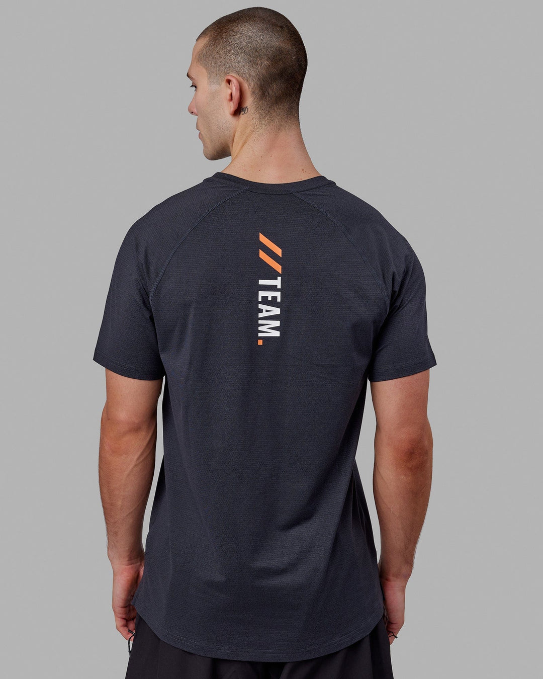 Man wearing LSKD x FS VapourFLX Trainer Tee - Black Marl - view 4