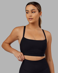 Woman Wearing Momentum Ribbed Sports Bra - Black | Thumbnail Index: 2