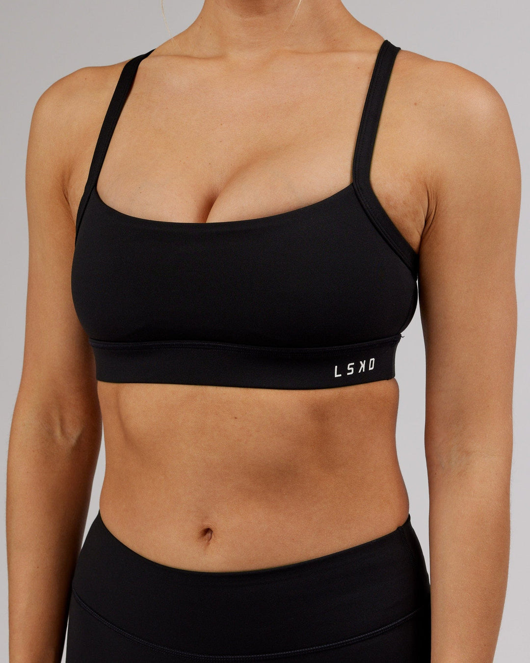 Woman wearing Momentum Sports Bra - Black - view 10