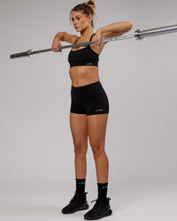 Woman wearing Momentum Sports Bra - Black | Thumbnail Index: 6