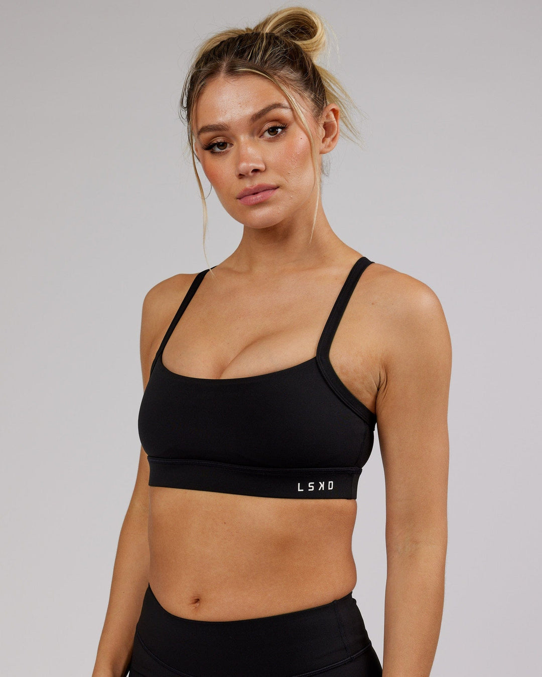 Woman wearing Momentum Sports Bra - Black - view 5