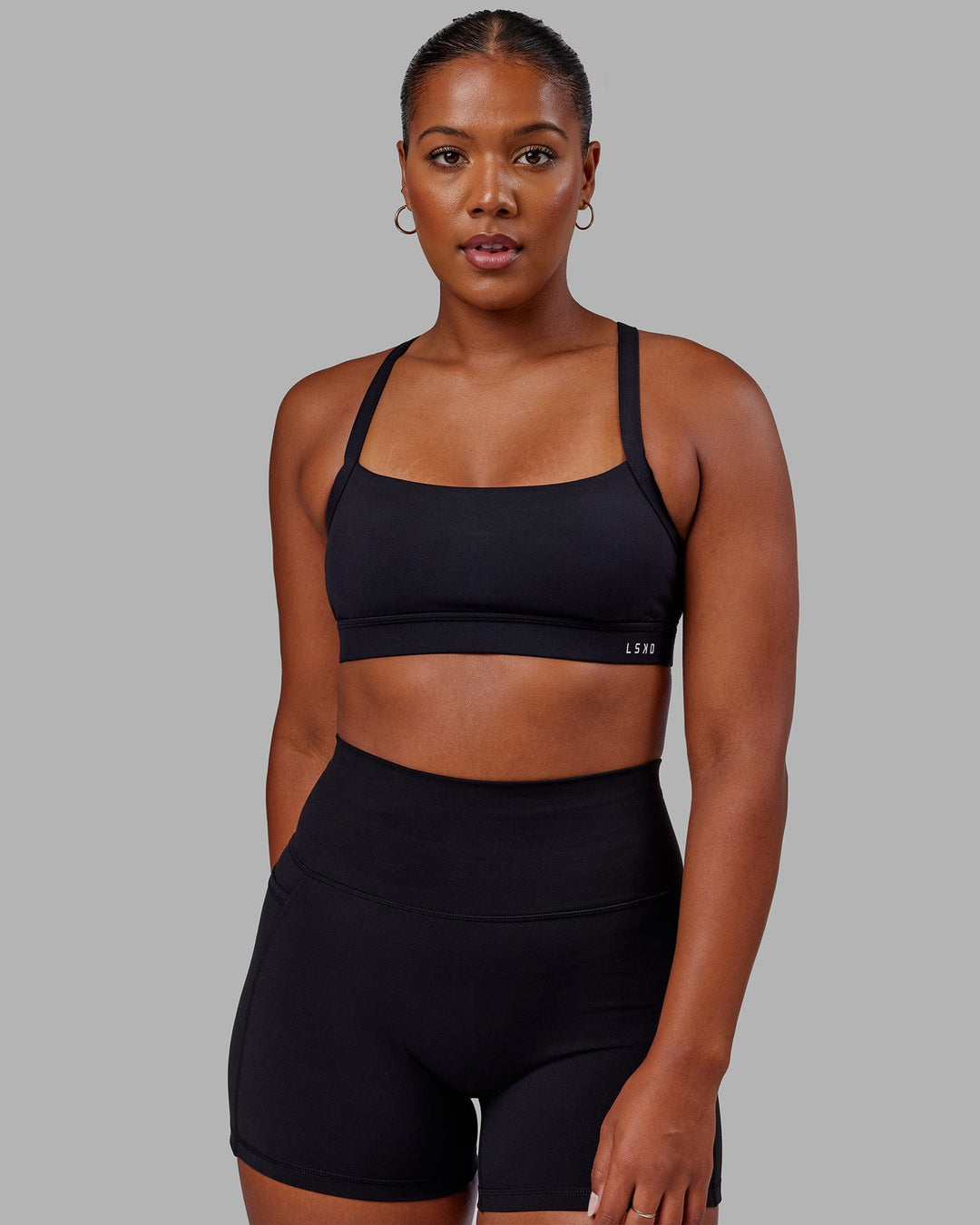 Woman wearing Momentum Sports Bra - Black - view 3