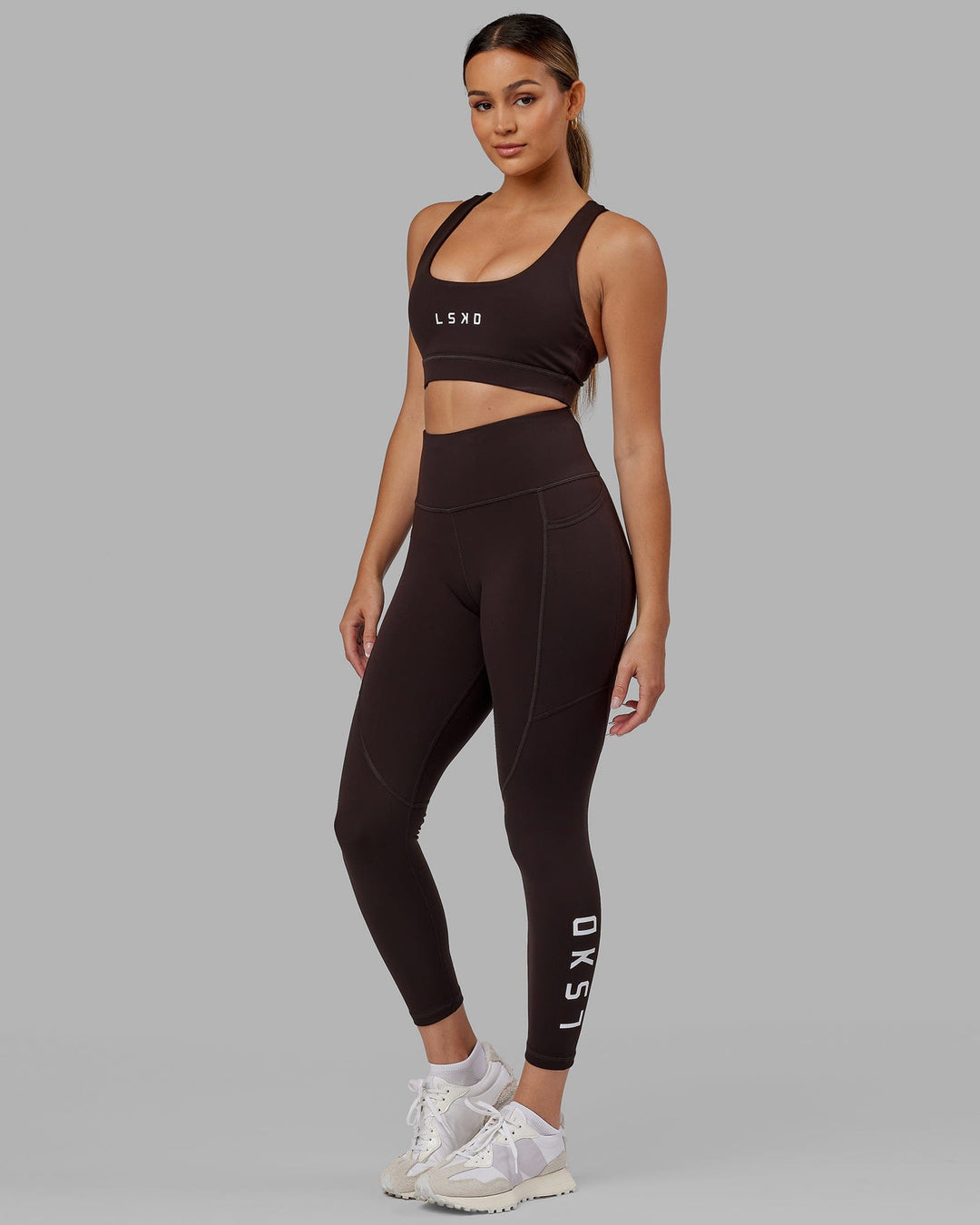Woman wearing Rep Ultra High-Rise 7/8 Legging Pockets - Dark Walnut | Model:Catalina | Size:S - view 1