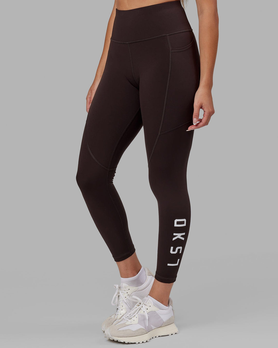 Woman wearing Rep Ultra High-Rise 7/8 Legging Pockets - Dark Walnut | Model:Catalina | Size:S - view 2